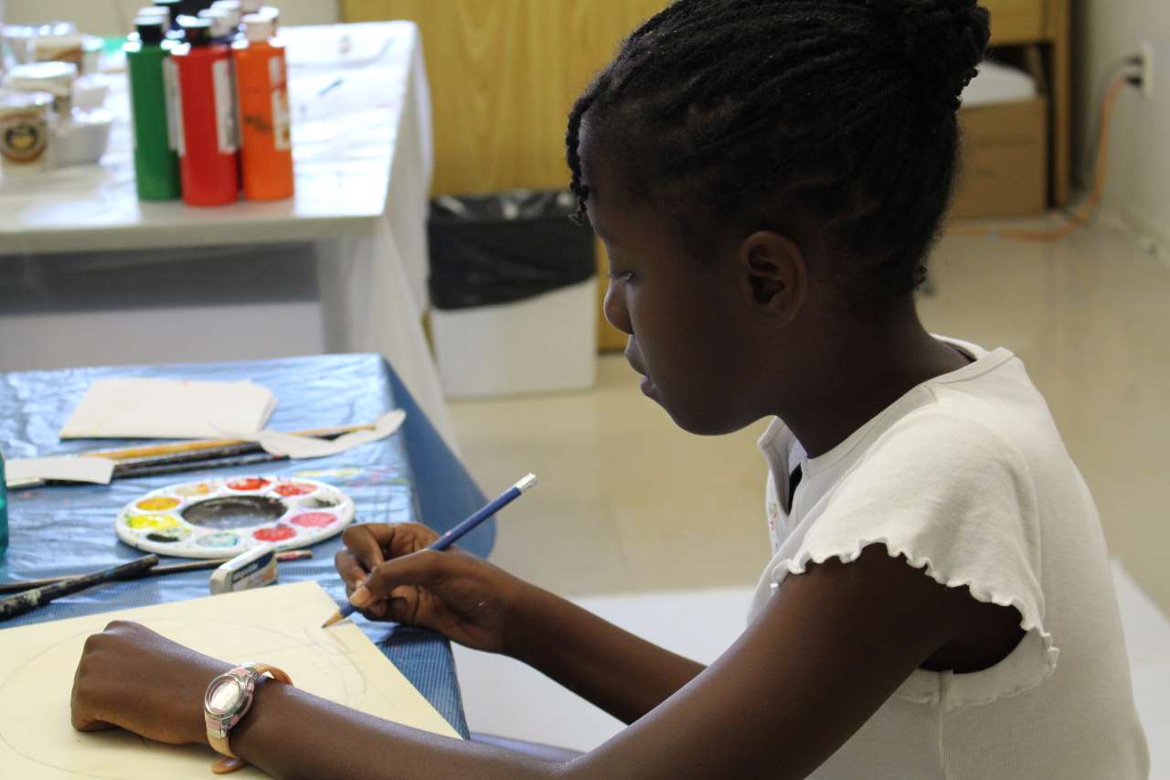 young artist painting at Centauri Arts Camp